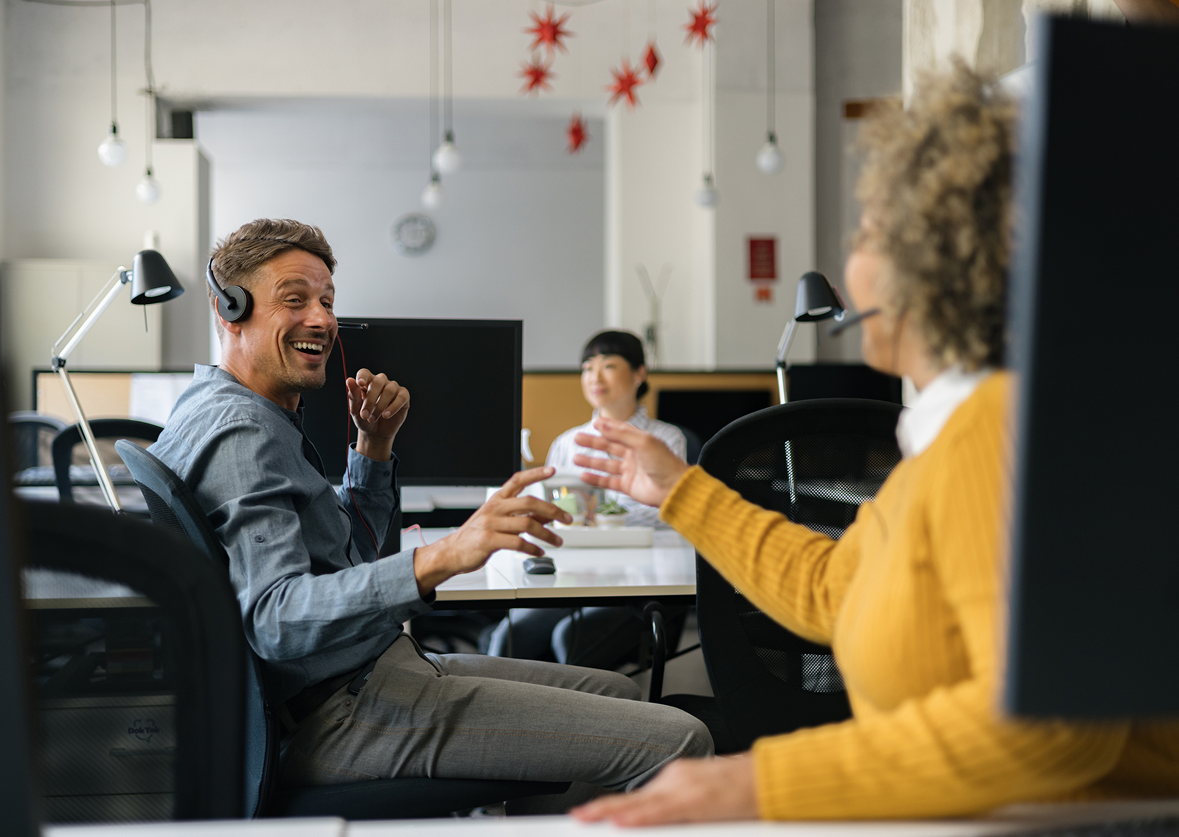 People wearing headsets in a modern office