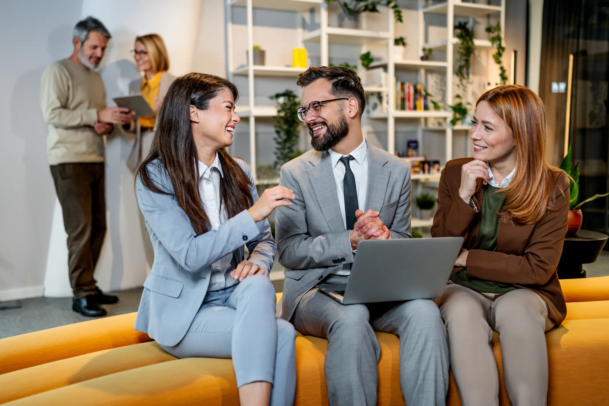 Colleagues laughing during an office meeting