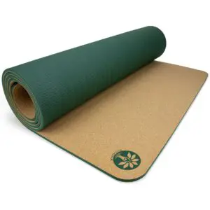 Aura cork yoga mat with fine-grain cork surface, rolled out on studio floor
