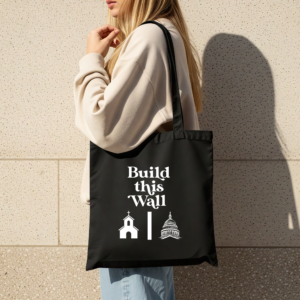 Black canvas tote bag with 'Build THIS Wall' political statement design